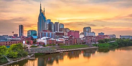 Nashville skyline at sunset reflected on the Cumberland River